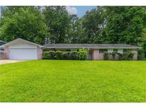 Charming single-story home with a large front yard and lush greenery, offering great curb appeal at 460 E Kildare Nw Ave, Atlanta, GA 30318