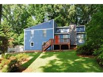 Charming blue two-story home with landscaped yard and cozy porch at 674 Crespan Ct, Lawrenceville, GA 30044