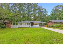 Charming remodeled single-story home featuring lush lawn and modern exterior at 2720 Cavalier Dr, Decatur, GA 30034