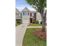 Charming townhouse with a brick facade, a one-car garage, and a well-manicured lawn and landscaping at 359 Azalea Cir, Cumming, GA 30028