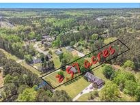 Beautiful 2.57 acre lot in a wooded, secluded area with an established home and long driveway at 1797 Chandler Rd, Lawrenceville, GA 30045