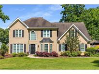 Charming two-story home with a well-manicured lawn and a traditional design at 4913 Farm Valley Ne Dr, Woodstock, GA 30188
