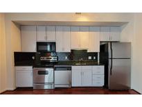 Well-lit kitchen features stainless appliances, dark countertops, and light-colored cabinets at 620 Glen Iris Ne Dr # 321, Atlanta, GA 30308