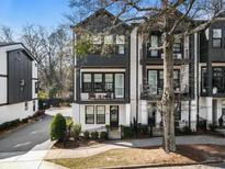 Beautiful three-story townhouse with modern black and white exterior and a well-manicured front yard at 92 Rogers Ne St, Atlanta, GA 30317