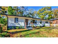Charming renovated brick ranch with professionally landscaped yard and modern painted details at 2047 Seavey Dr, Decatur, GA 30032