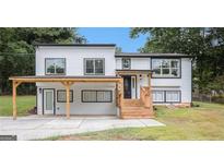 Charming renovated two-story home featuring new windows, modern finishes, and a welcoming covered porch area at 3831 Flakes Mill Rd, Decatur, GA 30034