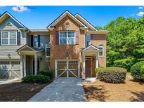 Charming two-story townhouse with brick facade, attached garage, and well-maintained landscaping at 1414 Dolcetto Nw Trce # 14, Kennesaw, GA 30152