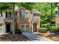 Charming two-story townhome with brick facade, shutters, and a two-car garage at 1414 Dolcetto Nw Trce # 14, Kennesaw, GA 30152