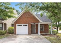 Charming brick home features a one-car garage, covered porch, and well-maintained front yard at 3063 Broadleaf Trl, Fairburn, GA 30213