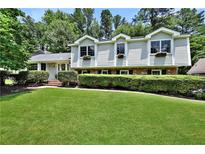 Charming two-story home with manicured lawn and lush landscaping, offering curb appeal at 3107 Bunker Hill Cir, Marietta, GA 30062