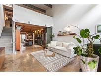 Inviting living room features an open floor plan, concrete floors, and a modern design at 1661 La France Ne St # 222, Atlanta, GA 30307