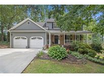 Charming two-story home with a well-manicured lawn and inviting front porch at 110 Windsor Chase Dr, Lawrenceville, GA 30043