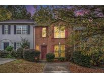 Charming brick townhome featuring well-maintained landscaping and cozy curb appeal at 338 Saratoga Pl, Riverdale, GA 30296