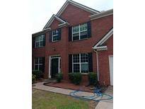 Two-story brick home with black shutters and well-manicured landscaping at 750 Ambrose Ln, Atlanta, GA 30349