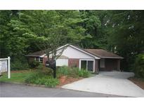 Charming brick home with a well-manicured front yard and an inviting entrance at 1102 Rogeretta Ne Dr, Atlanta, GA 30329