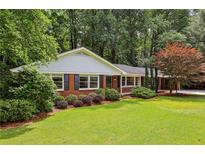 Charming one-story brick home with well-manicured lawn and mature trees at 2233 Clairmont Ne Rd, Atlanta, GA 30329