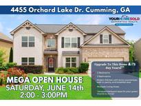 Charming two-story home featuring a combination of siding and brick, with a manicured front yard and inviting curb appeal at 4455 Orchard Lake Dr, Cumming, GA 30028