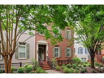 Charming two-story brick home with manicured landscaping and inviting front entrance and neutral shutters at 827 Perennial Dr, Atlanta, GA 30328