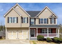 Charming two-story home with neutral siding, a two-car garage, and a welcoming front porch at 203 Overlook Ct, Dallas, GA 30157