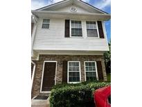Traditional two-story townhome with white siding, brick accents, and a well-manicured front yard at 3609 Ginnis Rd, Atlanta, GA 30331