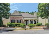 Charming one-story home with a well-maintained lawn and mature landscaping at 557 Pringle Dr, Suwanee, GA 30024