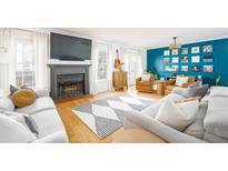 Bright living room featuring a fireplace, large TV, hardwood floors, and comfortable sofas at 1348 Sheffield Glen Ne Way # 8, Atlanta, GA 30329
