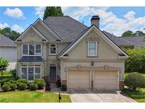 Charming two-story home featuring a manicured lawn, two-car garage, and neutral color scheme at 2459 Chestnut Lndg, Atlanta, GA 30360