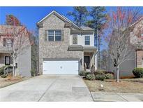 Charming two-story home with a well-manicured lawn and attached two-car garage at 68 Hardy Water Dr, Lawrenceville, GA 30045