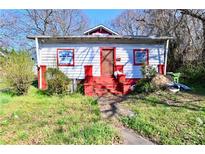 Charming home with red accents, a small porch, and a well-maintained front yard at 692 Moreland Se Ave, Atlanta, GA 30316