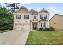 Charming two-story brick home with a well-manicured lawn and a two-car garage at 3586 Maple Hill Rd, Stonecrest, GA 30038