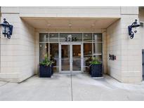 The building entrance features double glass doors, black flower boxes, and a secure access system at 2255 Peachtree Ne Rd # 620, Atlanta, GA 30309
