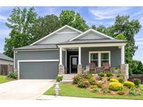 Charming home with a well-manicured lawn, inviting front porch, and neutral paint colors at 3026 Towne Mill Ave, Canton, GA 30114