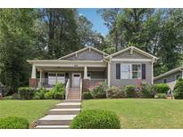 Charming home featuring a welcoming front porch, well-maintained lawn, and beautifully landscaped garden at 532 Lemon Ne St, Marietta, GA 30060