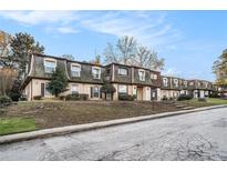 Inviting two-story condo complex with landscaped front and traditional architecture at 46 Le Parc Fontaine, Lithonia, GA 30038