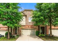 Charming townhome with a brick and stone exterior and well-maintained landscaping at 5534 Parkerton Ln, Atlanta, GA 30342