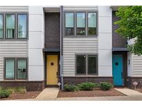 Modern townhome with colorful front doors, gray siding, and brick accents, set on a neatly landscaped lot at 415 Gartrell Se St # 15, Atlanta, GA 30312