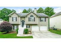 Charming two-story home with a manicured lawn and two-car garage at 5958 Tate Dr, Austell, GA 30106