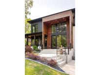 Stunning modern home featuring beautiful wood accents, black trim windows, and a landscaped front yard at 2469 River Oak Dr, Decatur, GA 30033