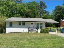 Charming single-story home with a white brick facade, covered porch, and well-maintained front yard at 3199 Nw Delmar Ln, Atlanta, GA 30311