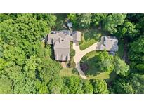 Aerial view of a private estate with a beautifully landscaped yard, mature trees, and multiple buildings at 654 Cannon Rd, Sharpsburg, GA 30277