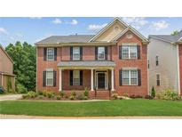Charming two-story brick home with black shutters, a covered porch, and manicured lawn at 2667 Hampton Park Dr, Marietta, GA 30062