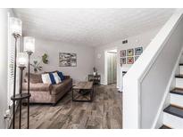 Comfortable living room featuring a cozy sofa, stylish decor, and wood-look laminate flooring at 3251 Abbeywood Dr, Decatur, GA 30034