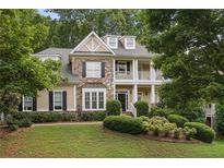 Charming two-story home featuring stone accents, dormer windows, front balcony and professionally landscaped front yard at 4874 Registry Nw Ln, Kennesaw, GA 30152