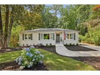 Charming brick home with landscaped front yard and cozy curb appeal surrounded by mature trees at 1600 Belle Isle Ne Cir, Atlanta, GA 30329