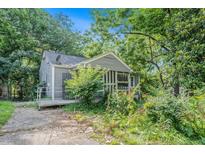 Charming bungalow-style home with a welcoming porch and lush landscaping at 239 Haas Se Ave, Atlanta, GA 30316