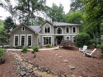 Charming two-story traditional home with inviting front yard, stone walkway, and manicured landscaping at 3962 Fox Glen Dr, Woodstock, GA 30189