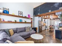 Bright living room with high ceilings, open shelving, and a comfortable sectional sofa at 1661 La France Stret Ne, Unit #216, Atlanta, GA 30307