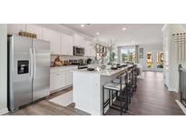 Bright, open kitchen features a large island, stainless steel appliances, and white cabinets at 220 College Cir # 1011, Hapeville, GA 30354
