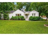 Charming white brick home with lush front yard and mature trees offers inviting curb appeal at 2119 Glenwood Se Ave, Atlanta, GA 30316