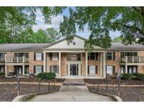 Brick condominium building featuring stately pillars and nicely landscaped common areas at 3650 Ashford Dunwoody Ne Rd # 811, Atlanta, GA 30319